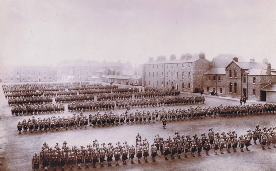 The Argyll and Sutherland Regiment in the parade square of Richmond Barracks, prepare to leave for the Boer war. Note the cottages on the right hand side for soldiers with families. Credit: Unknown.