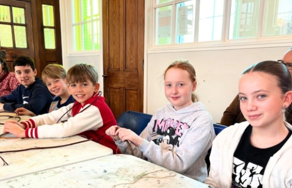 A group of children are sitting at a table