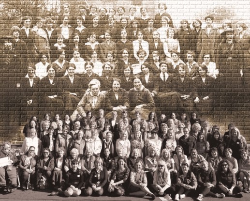 Women of the Yarn School sit below a photograph of the women and girls	who took part in the Easter Rising of 1916. Credit: Dublin City Council Culture Company.