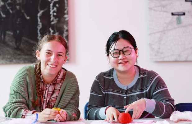 Two adults in workshop smiling