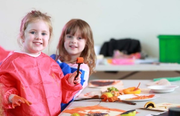 Two children painting at a table