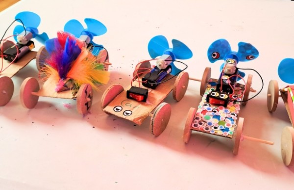 a group of toy cars that are made out of cardboard and wires