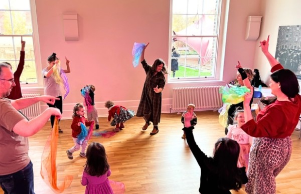 A group of adults and children dancing